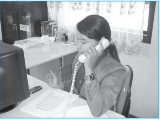 Seorang karyawati sedang menelepon di kantor
